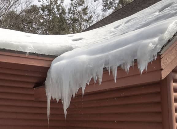 Ice damn on a cabin by calgary alberta in winter