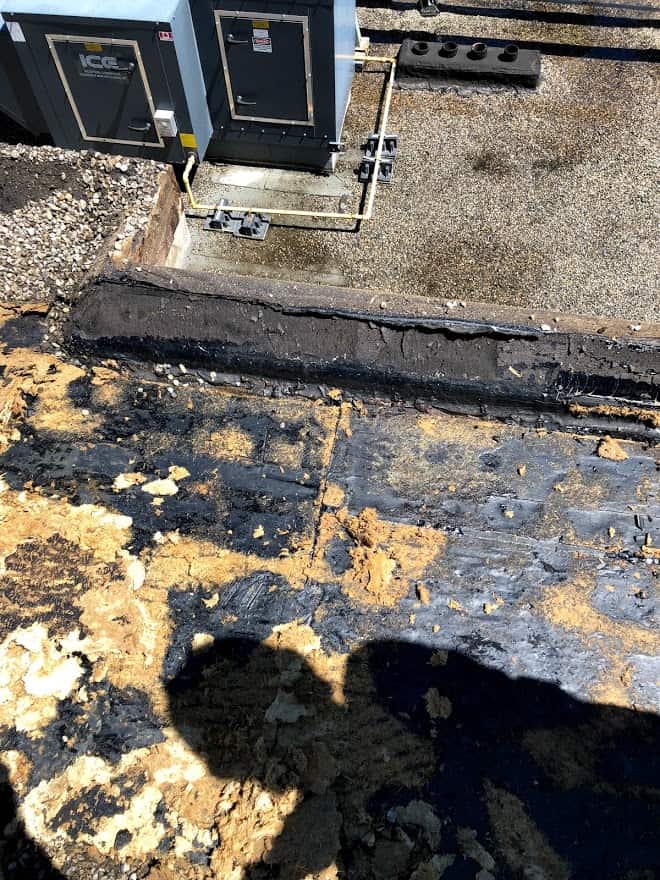 Calgary downtown roof inspection showing water damage on a flat roof