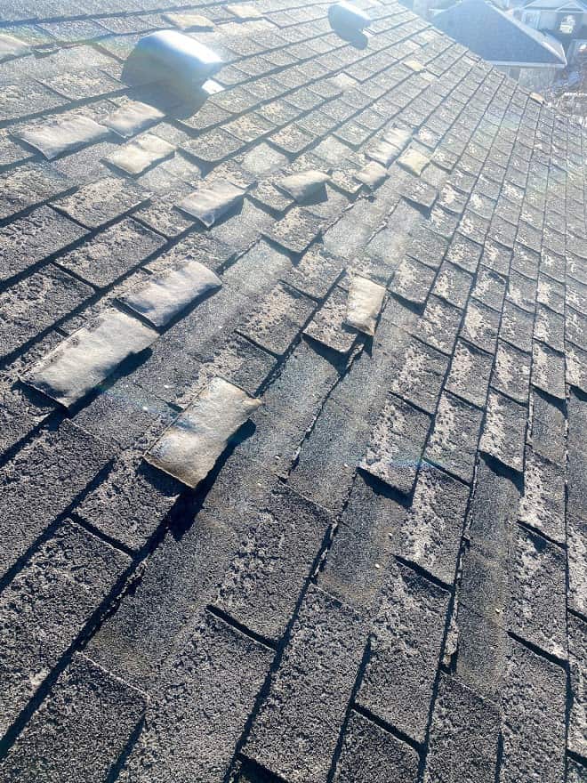 A roof in rocky ridge calgary that shows damage in spring after a harsh winter