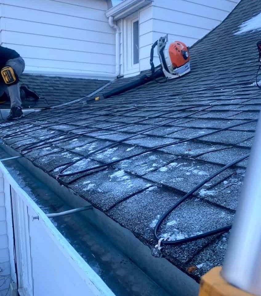 Heat cables being installed on a roof in Calgary