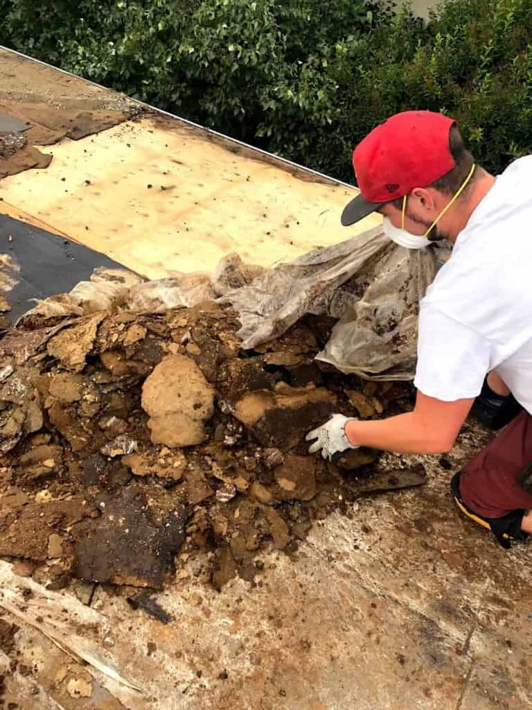 A damaged roof in Calgary, Alberta, being repaired by a professional from Whalley's Four Seasons Roofing.